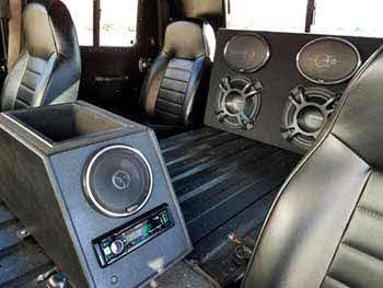 Hummer H1 (military model). Built a small basic center console to house Kenwood digital media receiver, a pair of 5.25" coax speakers and an amplifier with a storage area. Also custom built a subwoofer enclosure for 2 each 10" subs and a pair of 6X9 speakers. Center console was bed lined to match the interior.