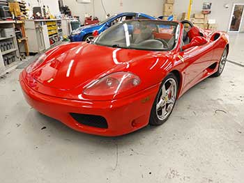'04 Ferrari 360 Spider. Installed Kenwood stereo with Hertz Audison component speakers and Rockford Fosgate 8" enclosed subwoofers mounted behind seat.