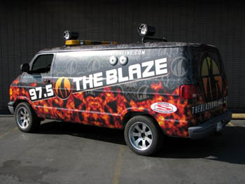 97.5 - The Blaze.  JVC I-Pod Direct Connect Receiver, Diamond Power Amplifiers, Rockford Fosgate Spakers, Bazooka Wakeboard Tower, Marine Speakers Mounted on the Roof, Clarion Marine Speakers on the Outside of the Van's Body.