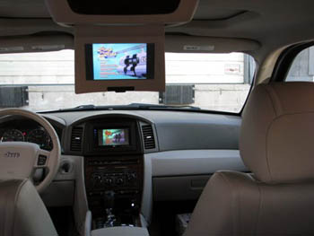 2006 Jeep Grand Cherokee - JVC Arsenal Multimedia with Navigation and Bluetooth, Integrated into Existing Factory Roof Mount Monitor, 15" Rockford Fosgate Subwoofer and Bass Box.