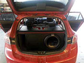 Custom built box for Rockford Fosgate 15" sub and 2 Rockford amps. Kenwood 6.1" Nav Entertainment System. Helix 5x7 Esprit Series coax speakers in rear. Used existing Kenwood 6.75" component systems.