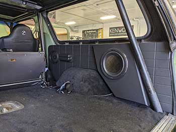 1979 Ford Bronco. Custom made side panels for the back half of this Bronco to match the rectangles found in the front panels. Installed 10" Kenwood subs in enclosures & speakers. Added sound dampening in the front doors. Installed Rockford Fosgate amp tucked away beyond the glove box. Also built a custom panel for a monitor by the glovebox to display the back up camera.