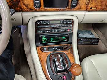 2001 Jaguar XKR. Made a custom dash kit that follows the curve of the OEM radio and console to house a Kenwood receiver. Also added satellite radio, steering wheel controls and a Kenwood 5-channel amp in the trunk.