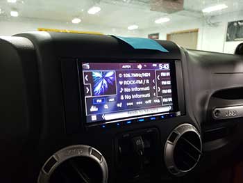 Jeep Wrangler. Installed all Kenwood components: 6.8" navigation entertainament system, amplifier, component & coax speakers, 12" shallow sub in a vehicle specific enclosure and a back up camera.