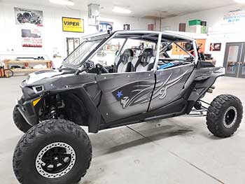 2017 Polaris RZR Turbo. We custom built a downfire vented enclosure for the cargo area. It's 100% 1" thick plastic (no wood) and is bed lined and mounted to the RZR. It has a custom grill for the vent pass through to the back seat. RZR already has a Rockford Fosgate Stage 5 kit. This upgrade gave the RZR a nice rich deep bass.